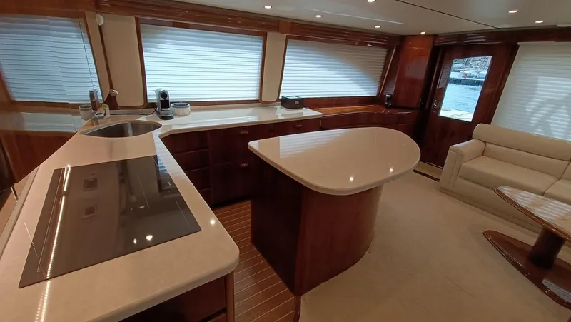 Slide: The Image of Luxurious interior of 2018 Viking 62 Enclosed Bridge yacht with modern kitchen and seating area. - 44