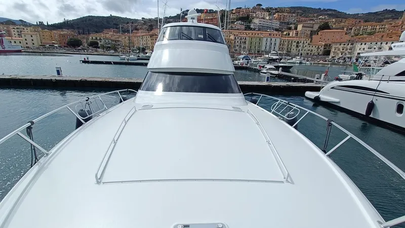 Slide: The Image of 2018 Viking 62 Enclosed Bridge yacht docked in a scenic marina. - 49