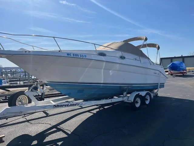 Slide: The Image of 1996 Sea Ray 270 Sundancer boat on trailer under clear blue sky. - 2