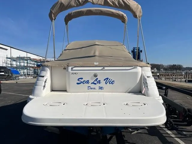 Slide: The Image of 1996 Sea Ray 270 Sundancer boat with "Sea La Vie" name, docked in a marina. - 4