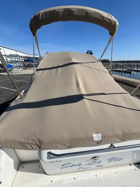 Slide: The Image of 1996 Sea Ray 270 Sundancer boat with beige cover and bimini top at marina. - 5