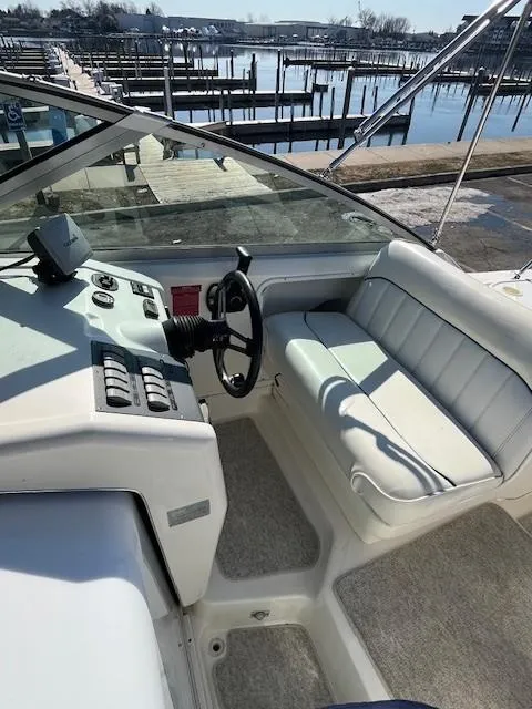 Slide: The Image of Interior view of a 1996 Sea Ray 270 Sundancer boat at a marina. - 9