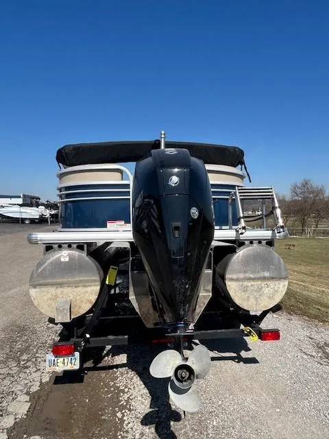 Slide: The Image of 2022 Sun Tracker Party Barge 22 XP3 pontoon boat with outboard motor, parked on gravel. - 3