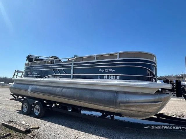 Slide: The Image of 2022 Sun Tracker Party Barge 22 XP3 pontoon boat on trailer, parked outdoors. - 4