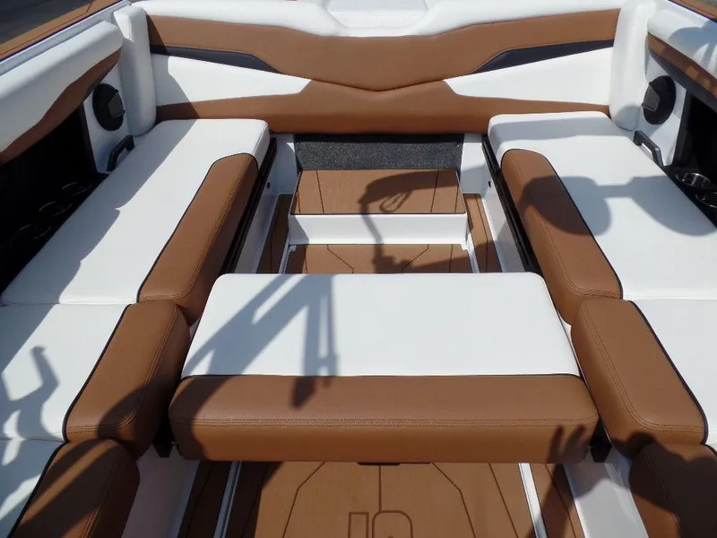 Slide: The Image of 2024 Axis T250 boat interior with brown and white seating. - 10