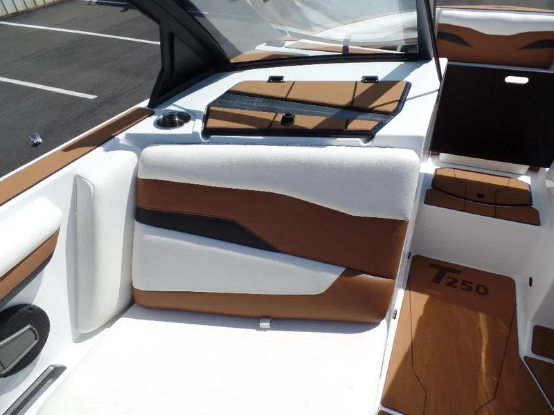 Slide: The Image of 2024 Axis T250 boat interior with brown and white seating, modern design. - 12
