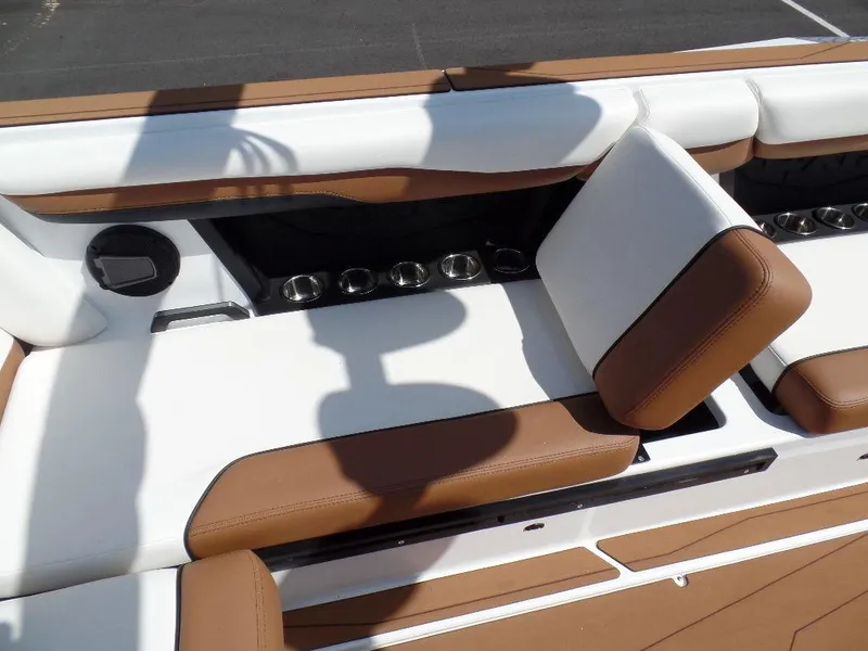 Slide: The Image of 2024 Axis T250 boat interior with brown and white seating and cup holders. - 13