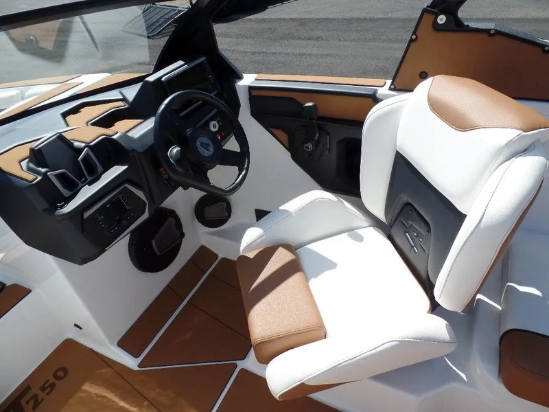 Slide: The Image of 2024 Axis T250 boat interior with white and brown seating, modern dashboard, and steering wheel. - 14