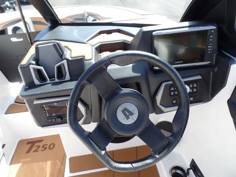 Slide: The Image of 2024 Axis T250 boat dashboard with steering wheel and navigation display. - 15