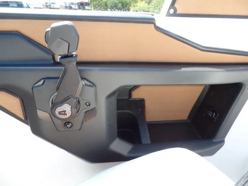 Slide: The Image of 2024 Axis T250 boat interior detail with storage compartment and control handle. - 16