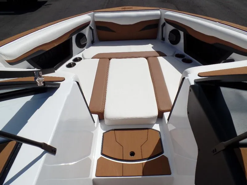 Slide: The Image of 2024 Axis T250 boat interior with white and brown seating and cup holders. - 18
