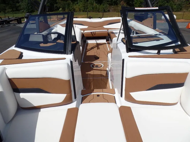 Slide: The Image of 2024 Axis T250 boat interior with tan and white seating, open windshield, and sleek design. - 20