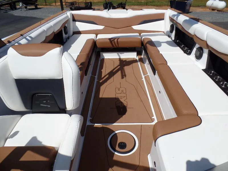Slide: The Image of 2024 Axis T250 boat interior with brown and white seating, spacious layout, and modern design. - 21