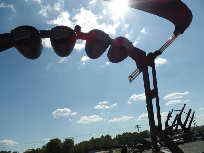 Slide: The Image of 2024 Axis T250 boat tower silhouetted against a bright sky with scattered clouds. - 22