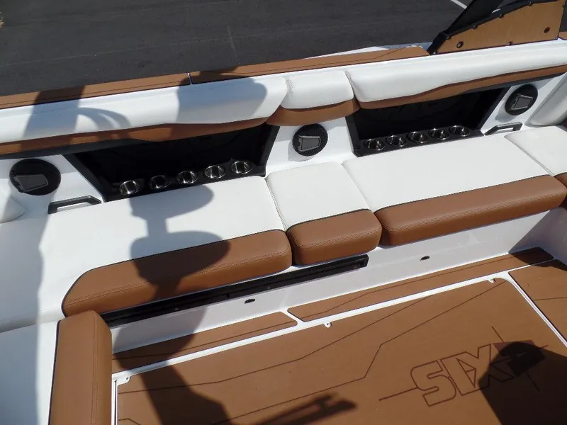 Slide: The Image of 2024 Axis T250 boat interior with brown and white seating and cup holders. - 8
