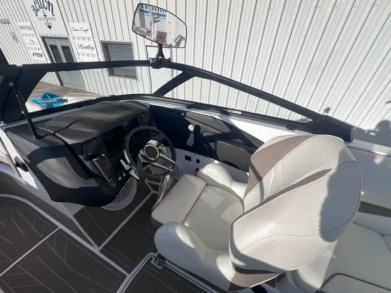 Slide: The Image of 2022 Centurion Fi25 boat interior with modern dashboard and comfortable seating. - 10