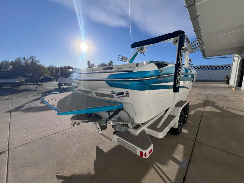 Slide: The Image of 2022 Centurion Fi25 boat on trailer under sunny sky. - 5