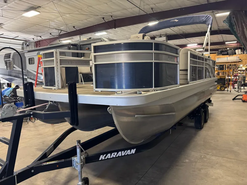 Slide: The Image of 2020 Bennington SX 22 SSRX pontoon boat on Karavan trailer in a warehouse. - 0