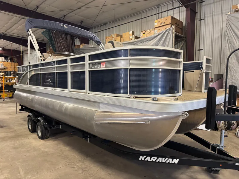 Slide: The Image of 2020 Bennington SX 22 SSRX pontoon boat on Karavan trailer in warehouse. - 1