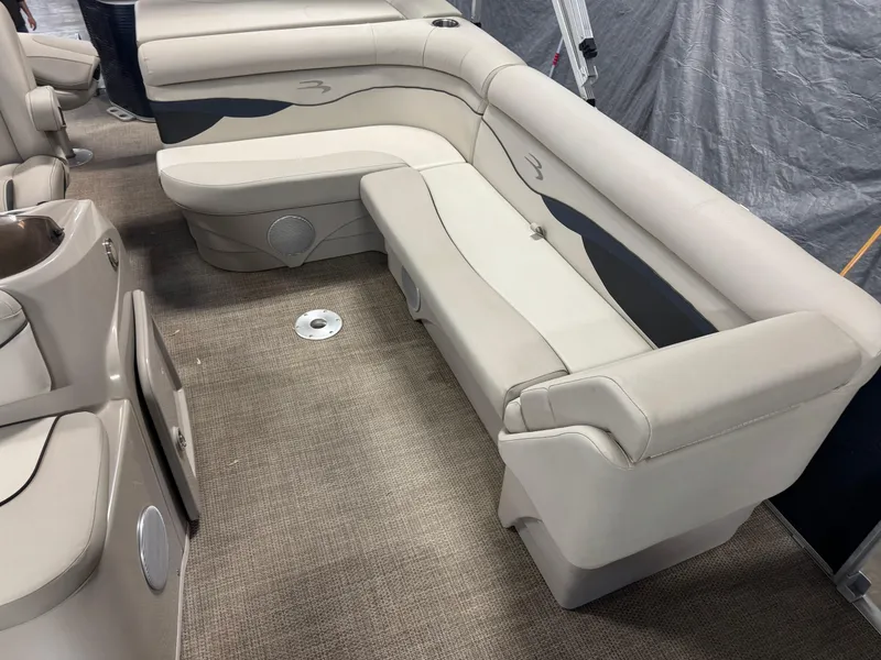 Slide: The Image of 2020 Bennington SX 22 SSRX boat interior with beige seating and carpeted floor. - 13