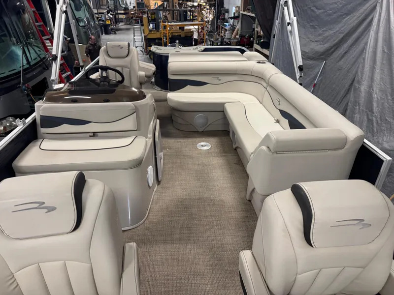 Slide: The Image of 2020 Bennington SX 22 SSRX pontoon boat interior with beige seating and helm. - 14