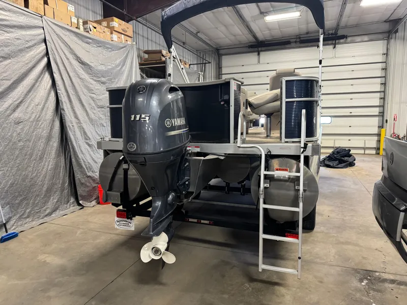 Slide: The Image of 2020 Bennington SX 22 SSRX pontoon boat with Yamaha 115 engine in a storage facility. - 4