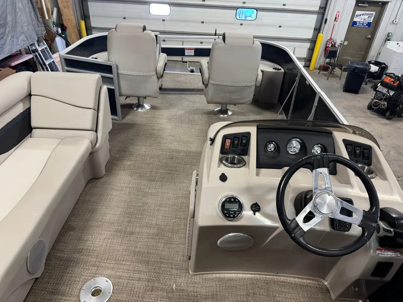 Slide: The Image of 2020 Bennington SX 22 SSRX pontoon boat interior with beige seating and steering console. - 8