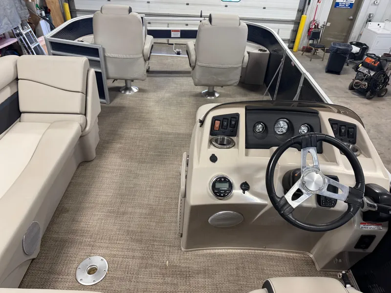 Slide: The Image of 2020 Bennington SX 22 SSRX pontoon boat interior with beige seating and steering console. - 9
