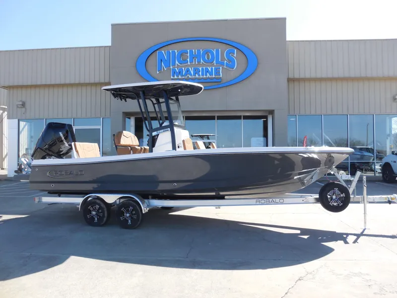Slide: The Image of 2025 Robalo 246 Cayman boat displayed at Nichols Marine dealership. - 1