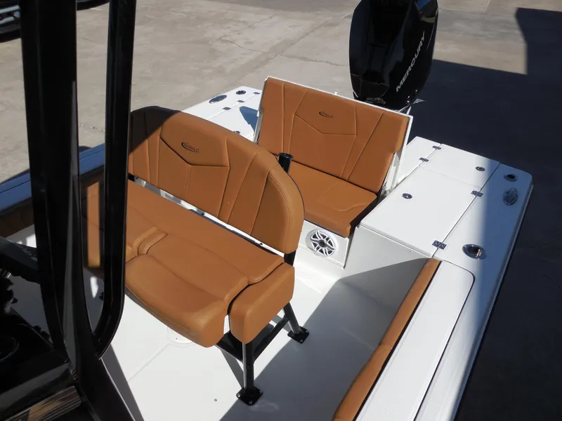 Slide: The Image of 2025 Robalo 246 Cayman boat interior with tan seating and white deck. - 10