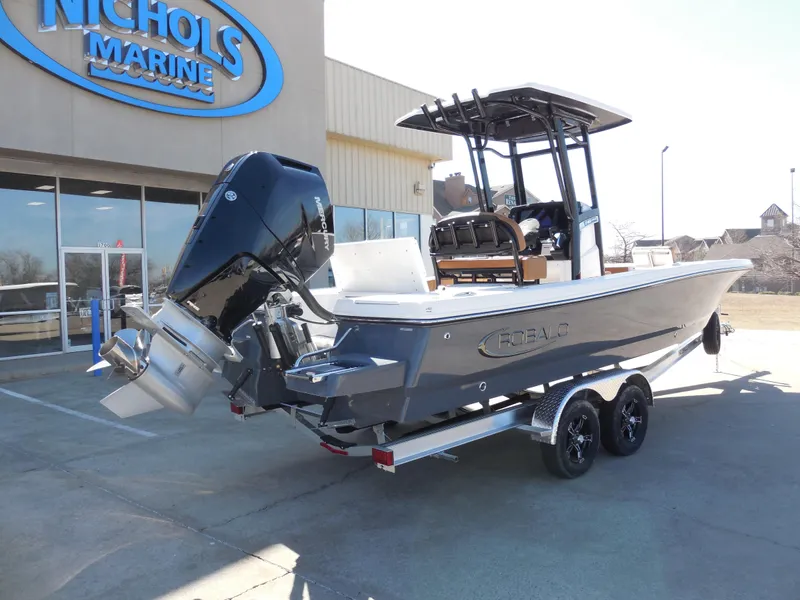 Slide: The Image of 2025 Robalo 246 Cayman boat on trailer outside Nichols Marine dealership. - 3