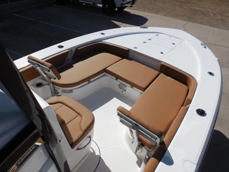 Slide: The Image of 2025 Robalo 246 Cayman boat interior with tan seating and white deck. - 8