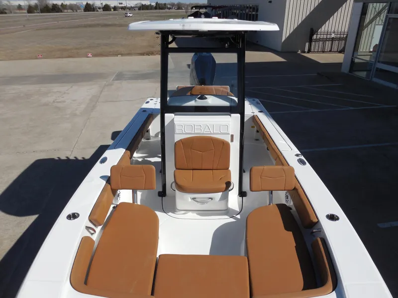 Slide: The Image of 2025 Robalo 246 Cayman boat with tan seating and sleek design. - 9