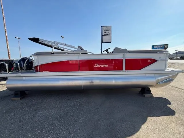 Slide: The Image of 2025 Barletta Cabrio 22QC pontoon boat with red and silver design, displayed outdoors. - 0