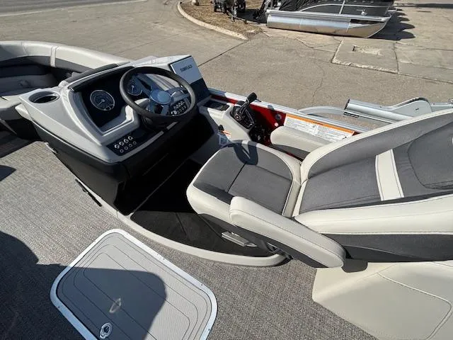 Slide: The Image of 2025 Barletta Cabrio 22QC boat interior with steering console and seating. - 13