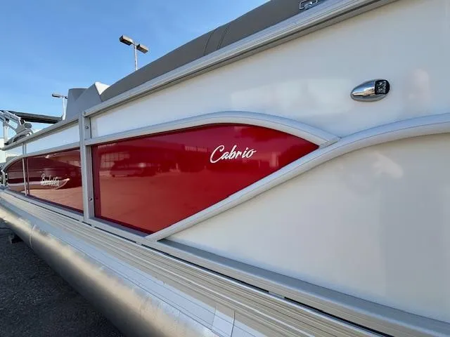 Slide: The Image of 2025 Barletta Cabrio 22QC pontoon boat with red and white exterior design. - 30