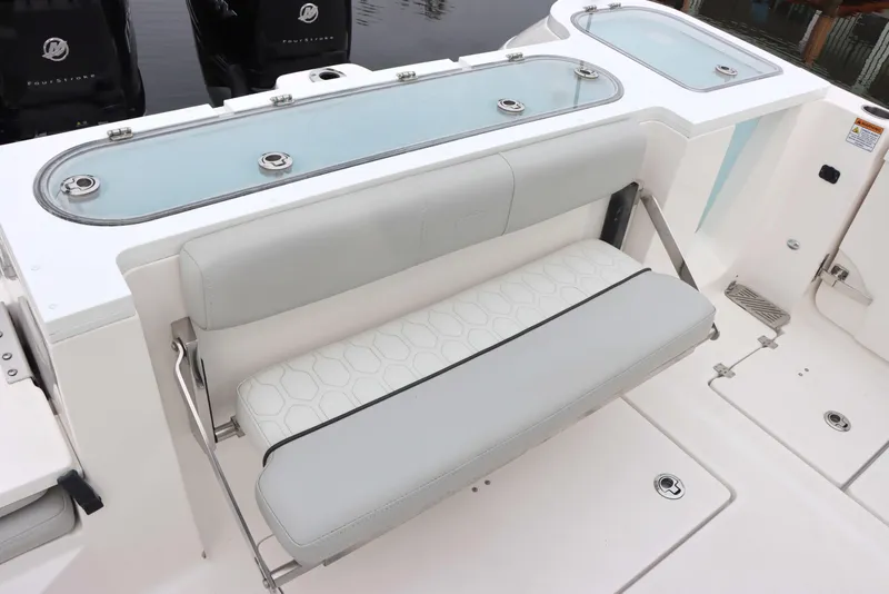 Slide: The Image of 2023 Sea Fox 328 Commander boat with sleek seating and storage compartments. - 12