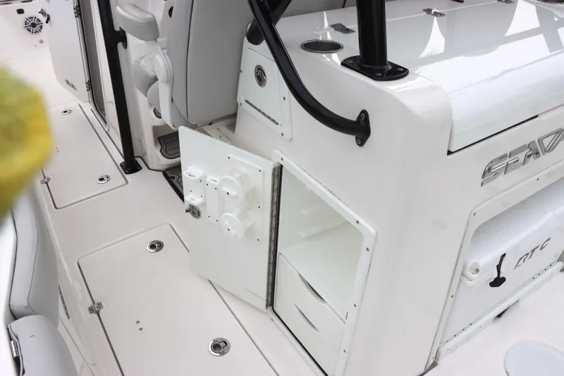 Slide: The Image of 2023 Sea Fox 328 Commander boat interior with open storage compartment and control panel. - 14