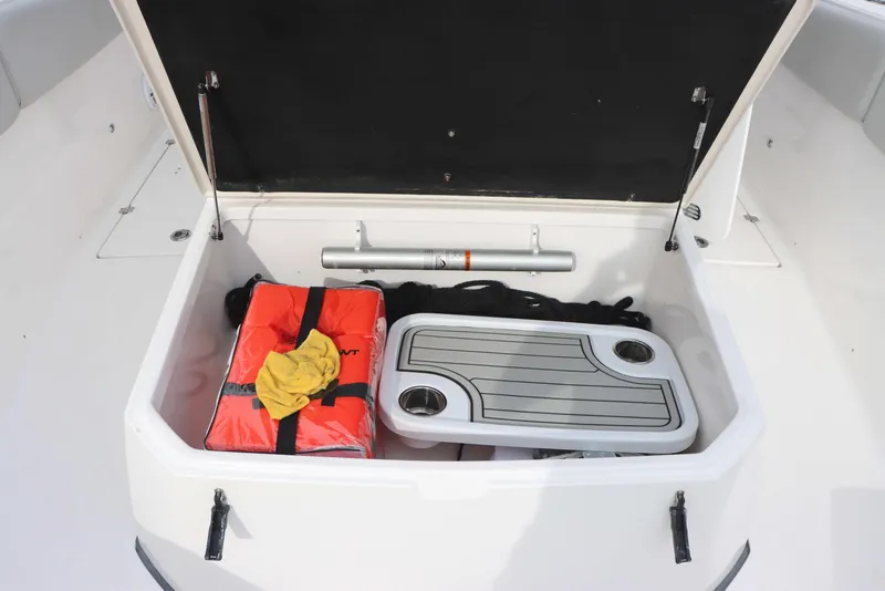 Slide: The Image of Open storage compartment on 2023 Sea Fox 328 Commander boat with safety gear and accessories. - 16