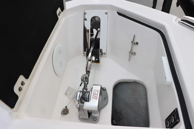 Slide: The Image of 2023 Sea Fox 328 Commander anchor compartment with winch and cleat. - 17