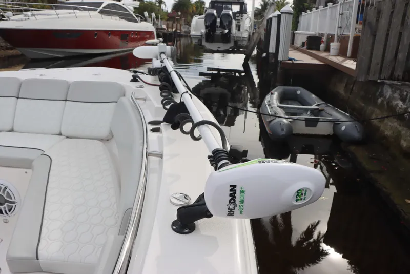 Slide: The Image of 2023 Sea Fox 328 Commander boat docked, featuring a Minn Kota trolling motor. - 19