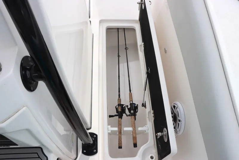 Slide: The Image of 2023 Sea Fox 328 Commander fishing rod storage compartment with rods secured inside. - 34