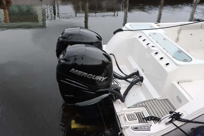 Slide: The Image of 2023 Sea Fox 328 Commander with dual Mercury outboard engines, docked on calm water. - 37
