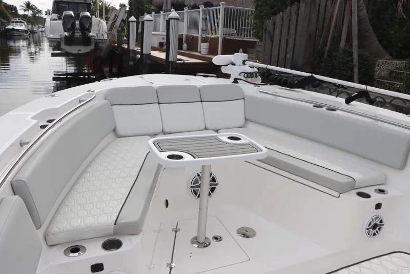 Slide: The Image of 2023 Sea Fox 328 Commander boat with spacious seating and table in a canal setting. - 4