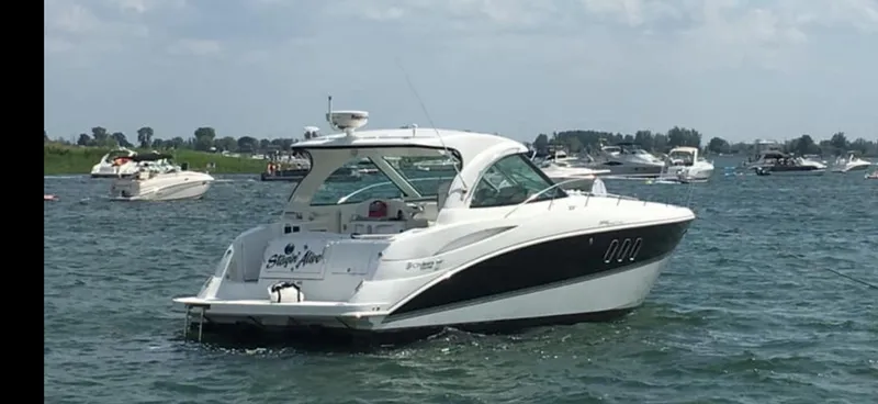 Slide: The Image of 2012 Cruisers Yachts 390 Sports Coupe on water, surrounded by other boats. - 0