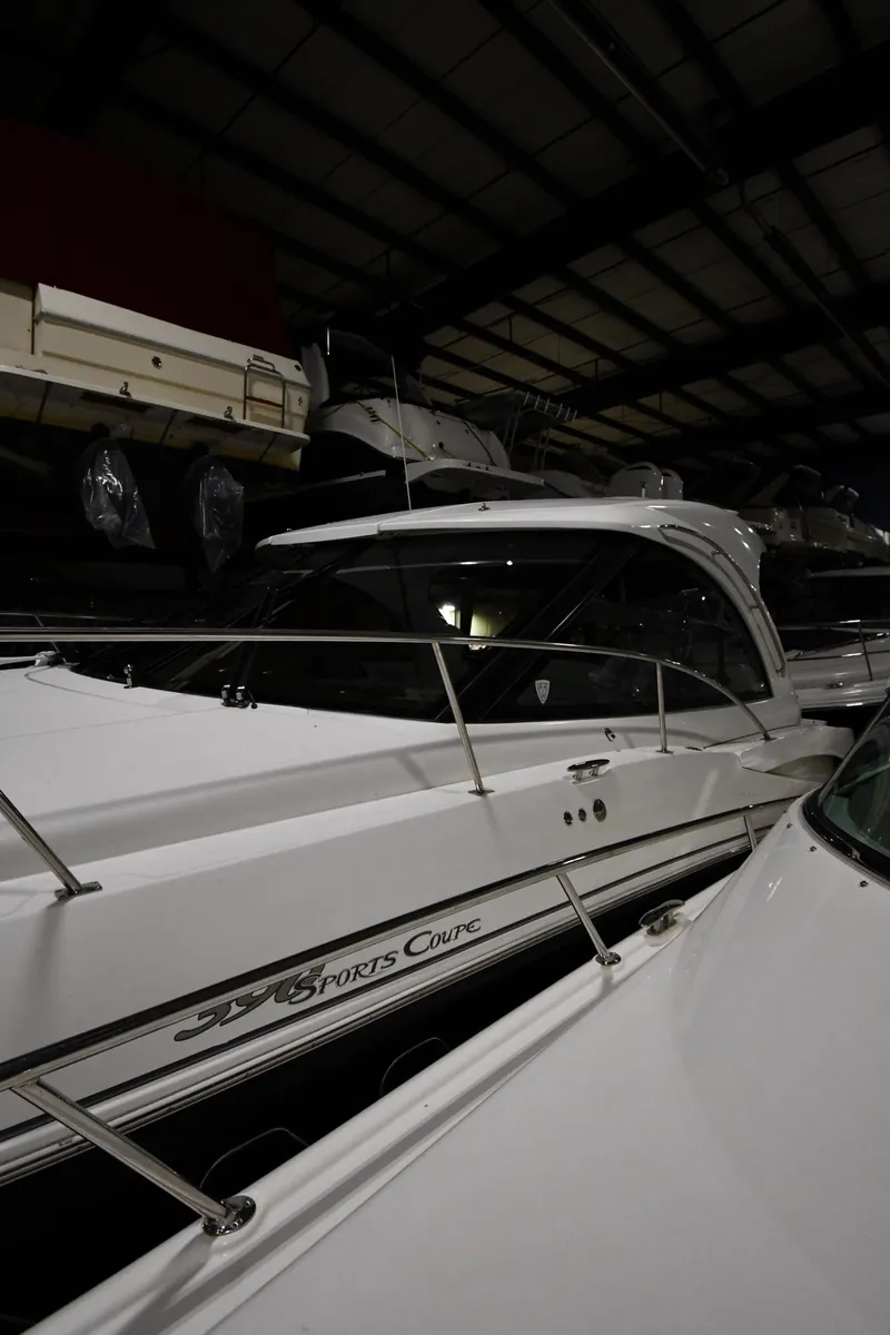 Slide: The Image of 2012 Cruisers Yachts 390 Sports Coupe in a dimly lit storage facility. - 2
