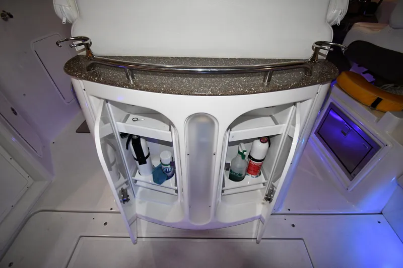 Slide: The Image of 2012 Cruisers Yachts 390 Sports Coupe interior storage with open cabinets and countertop. - 24