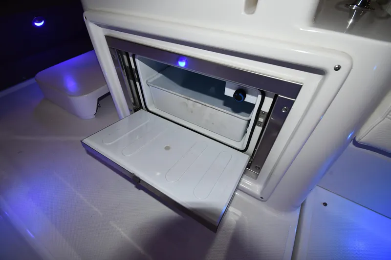 Slide: The Image of Open storage compartment on 2012 Cruisers Yachts 390 Sports Coupe with blue LED lighting. - 25