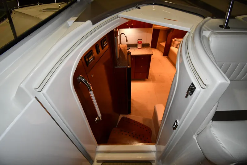 Slide: The Image of Interior view of 2012 Cruisers Yachts 390 Sports Coupe, featuring a cozy cabin entrance. - 26