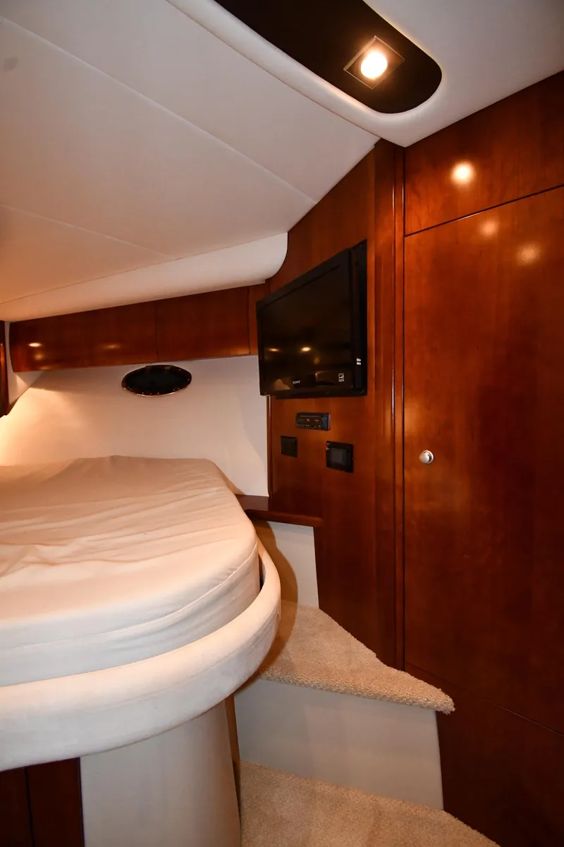 Slide: The Image of Interior of 2012 Cruisers Yachts 390 Sports Coupe with bed and wooden cabinetry. - 29